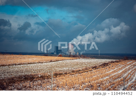 Panoramic view of nuclear power plant with wheat field Nuclear power plant cooling towers, big chimneys 110494452