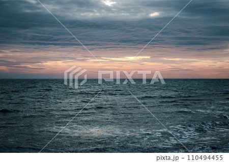 Winter Mediterranean sea waves landscape photo. Peaceful sunset time. Calm waves during vacation. 110494455