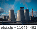 Building a nuclear power plant towers. Big chimneys beside road with partly cloudy sky. 110494462