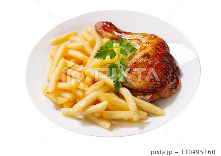 plate of baked chicken leg with french fries on white background plate of baked chicken leg with french fries on white background 110495160