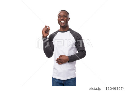 young stylish confident american man dressed casually in a black and white sweatshirt points his 110495974