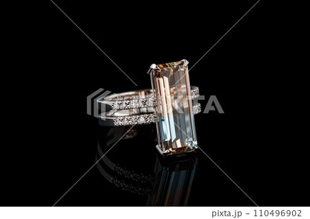 beautiful gold ring with topaz gemstones on a black background 110496902