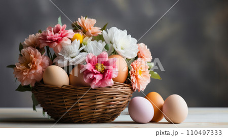 Charming composition of wicker basket, pastel-colored eggs and vibrant mix of spring flowers, pink dahlias, white chrysanthemums, against grey background, Easter spring basket with floral decoration Charming composition of wicker basket, pastel-colored eggs and vibrant mix of spring flowers, pink dahlias, white chrysanthemums, against grey background, Easter spring basket with floral decoration 110497333