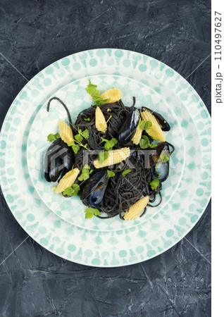 Black pasta with mussels and corn. 110497627