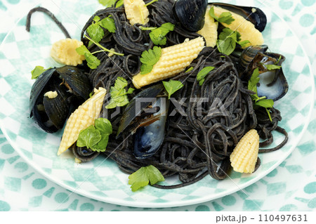 Black spaghetti pasta with mussels. 110497631
