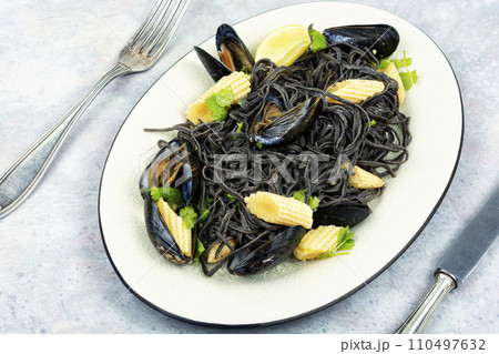 Mussels and black pasta. 110497632