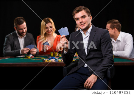 Young people playing poker at the table. Casino 110497852