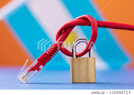 A closed lock on a tied network wire into a knot against the background of the Argentine flag, the concept of security of Internet technologies in Argentina 110498723