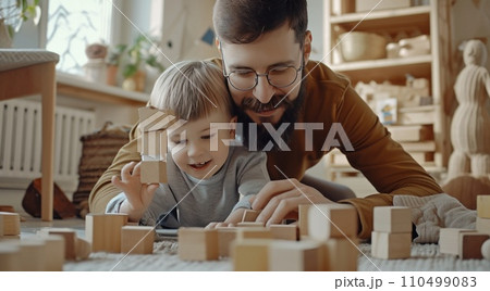 father and son building towers together while playing 110499083