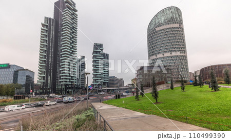 Panorama showing skyscrapers and biblioteca from park with green lawn timelapse in Milan Panorama showing skyscrapers and biblioteca from park with green lawn timelapse in Milan 110499390