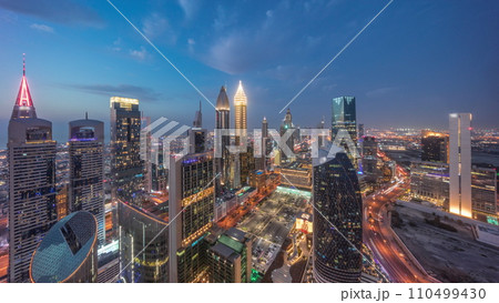 Skyline view of the high-rise buildings on Sheikh Zayed Road in Dubai aerial day to night timelapse, UAE. Skyline view of the high-rise buildings on Sheikh Zayed Road in Dubai aerial day to night timelapse, UAE. 110499430