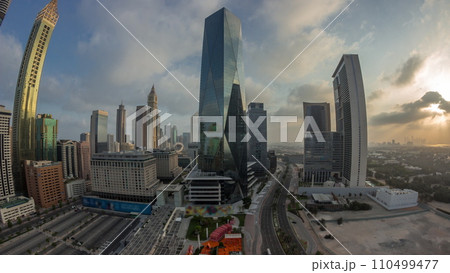 Panorama of Dubai International Financial district aerial night to day timelapse. View of business office towers. Panorama of Dubai International Financial district aerial night to day timelapse. View of business office towers. 110499477