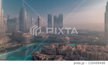 Aerial view morning fog covered Dubai International Financial Centre district timelapse 110499486