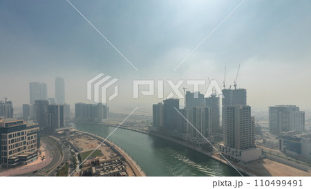 Modern city architecture in Business bay district before sunrise. Panoramic view of Dubai's skyscrapers all night timelapse 110499491