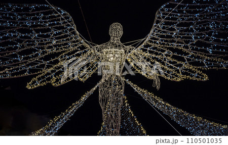 Flying angel Christmas decoration led lights display. Dramatic view of the traditional Christmas decoration lights hanging above Regent Street during dusk. Flying angel Christmas decoration led lights display. Dramatic view of the traditional Christmas decoration lights hanging above Regent Street during dusk. 110501035