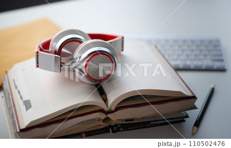 Headphones are on the table in the office Headphones are on the table in the office 110502476