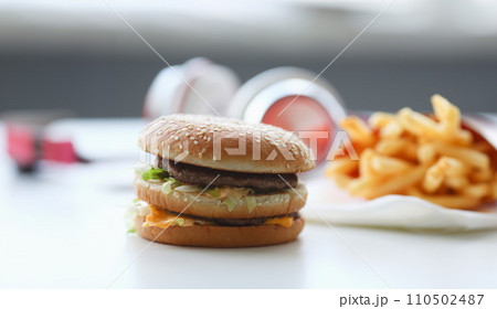 Hamburger and french fries with headphones Hamburger and french fries with headphones 110502487