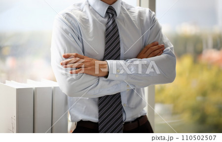 Male hands in suit crossed on chest closeup background Male hands in suit crossed on chest closeup background 110502507