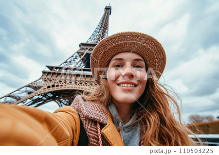 Young female traveller taking selfie with background of Eiffel tower. Generative AI. 110503225