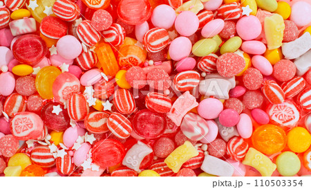Freeze motion of flying various kind of candies. Colored abstract sweet background. 110503354