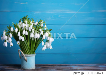 Bouquet of snowdrops on a wooden blue background 110504671