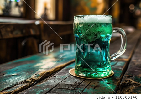 A glass of green beer on a table in a pub. St Patrick's day, holidays and celebration concept 110506140