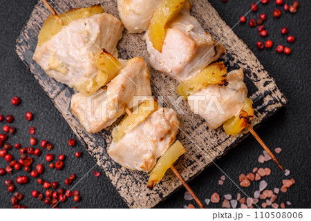 Delicious chicken or turkey kebab with pineapple pieces on skewers 110508006