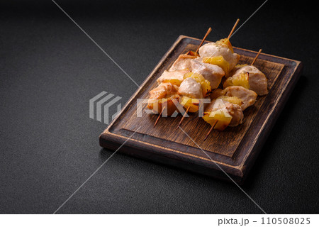 Delicious chicken or turkey kebab with pineapple pieces on skewers Delicious chicken or turkey kebab with pineapple pieces on skewers 110508025