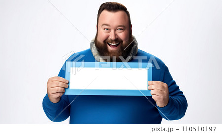 Cheerful bearded man holding a blue frame and looking at the camera. Portrait of a smiling bearded man in blue sweater and scarf holding a blank picture frame on white background. 110510197