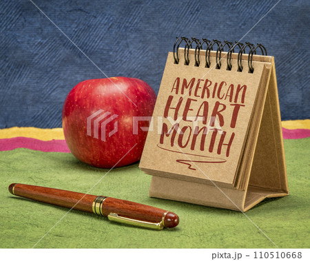 American Heart Month - observance held annually in February, reminder note in a desktop calendar, cardiovascular health concept. American Heart Month - observance held annually in February, reminder note in a desktop calendar, cardiovascular health concept. 110510668