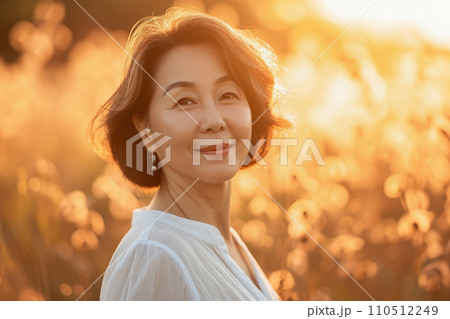 AI-generated content. Middle aged woman Asian enjoying outdoor in summer. Aesthetic golden hour close up portrait 110512249