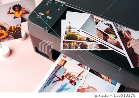Modern laser printer printing color photos of women close up Modern laser printer printing color photos of women close up 110513279