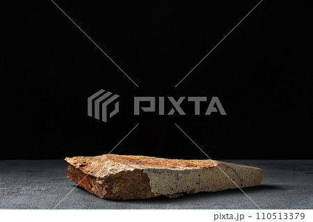 Piece of granite stone against black background 110513379