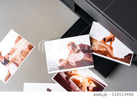 Modern laser printer printing color photos of women close up 110513406