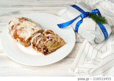 Christmas stollen on plate on white wooden table 110513455