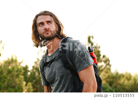 Portrait of hiker man with backpack trekking in the mountains Portrait of hiker man with backpack trekking in the mountains 110513555