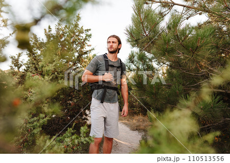 Portrait of hiker man with backpack trekking in the mountains 110513556