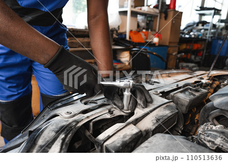 Close up of hands of auto mechanic working in a garage Close up of hands of auto mechanic working in a garage 110513636