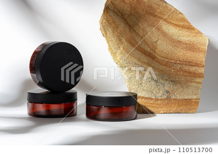 Cosmetic product jar in composition with granite stones and shadow 110513700