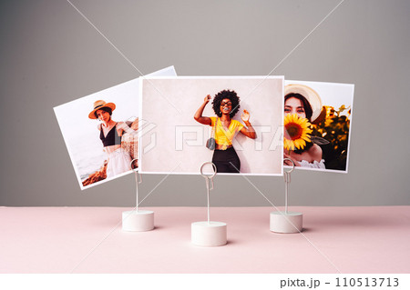 Printed colorful photos of women portraits against gray background Printed colorful photos of women portraits against gray background 110513713