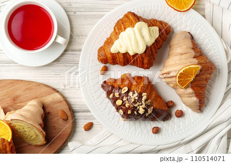 Fresh croissants with cup of tea on table 110514071