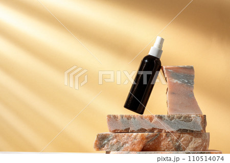 Cosmetic package dispenser with granite stone studio shot Cosmetic package dispenser with granite stone studio shot 110514074