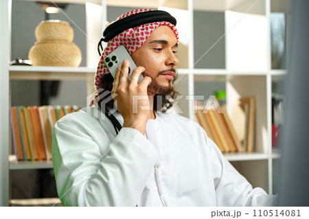 Young Arab businessman talking on the phone in the office 110514081