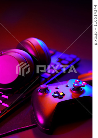 Headphones, joystick and computer keyboard on black table 110514344