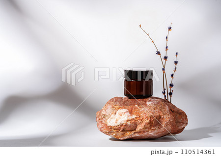 Cosmetic product jar in composition with granite stones and shadow 110514361