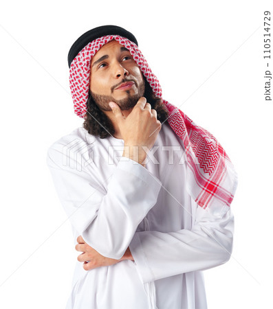 Pensive young man in traditional middle-east dress thobe on white background 110514729