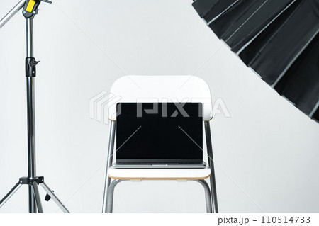 Laptop with black screen and photography equipment in photostudio 110514733