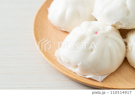 stuffed steamed bun on wood plate 110514917