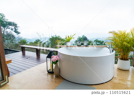 outdoor bath tub with beautiful mountain view background outdoor bath tub with beautiful mountain view background 110515621