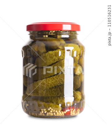 Cornichons, pickled gherkins in a glass jar. Crunchy pickles. Small cucumbers, pasteurized and preserved in brine of vinegar, salt, mustard seeds and chilis. Close-up, front view on white background. 110516231